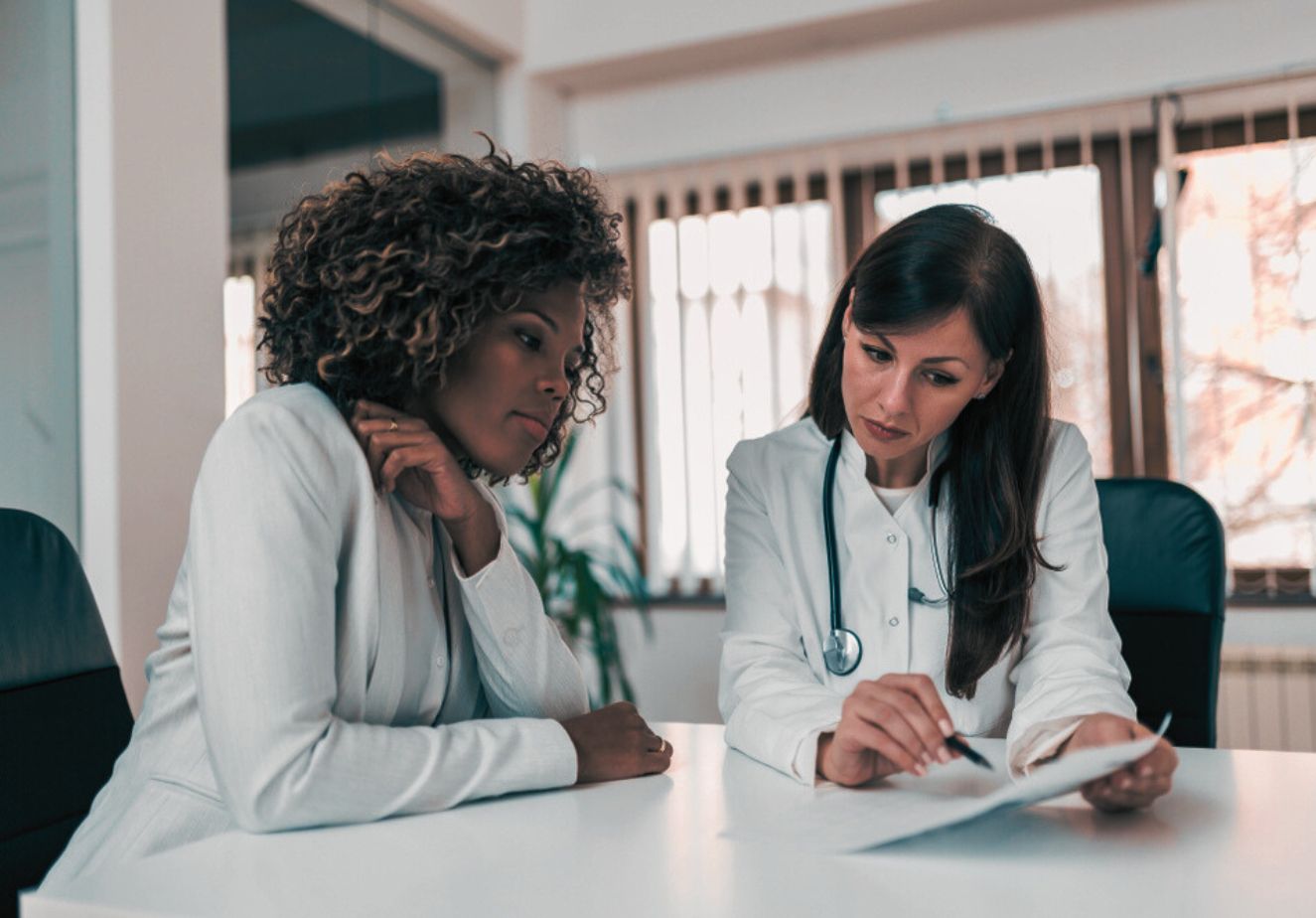 two female doctors discussing a treatment plan